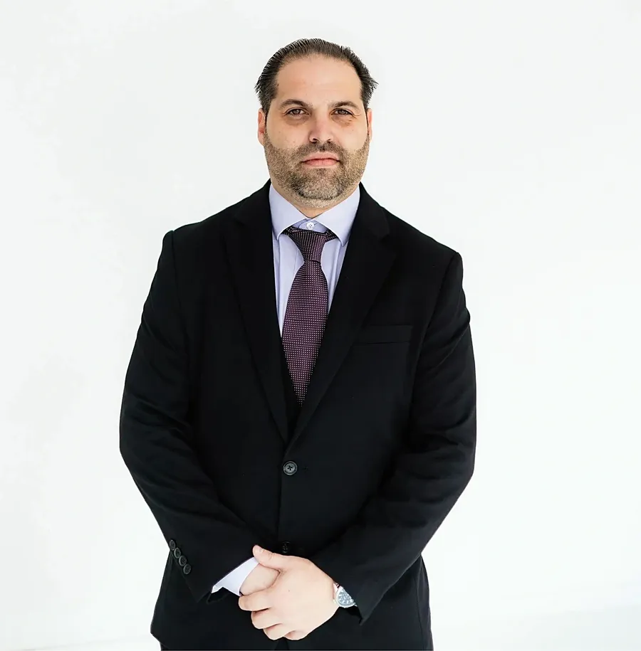 Miles Joslin, CEO of Uptown Roofing & Co., in a dark suit and tie